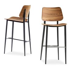 two wooden barstools with black metal legs and one has a bent backrest