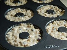 a muffin tin filled with oatmeal and raisins