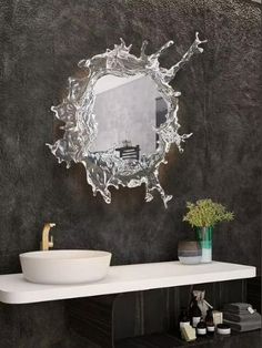 a bathroom with a sink and mirror on the wall above it's countertop