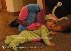 a baby is laying on the floor next to a stuffed animal