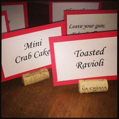 four wine cork place cards on a table