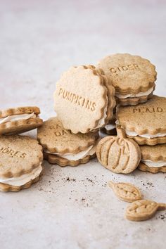 some cookies are stacked on top of each other with the word pumpkins written on them