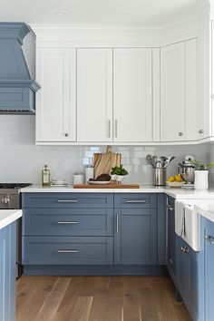 a kitchen with blue cabinets and white counter tops