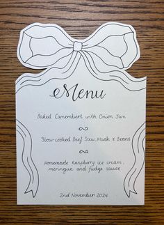 the menu for an event with a bow on it