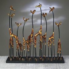 a group of giraffes standing next to each other on top of a table