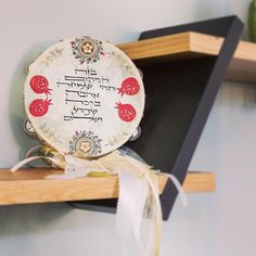 two wooden shelves with decorative plates on top of each shelf, decorated with red and white designs