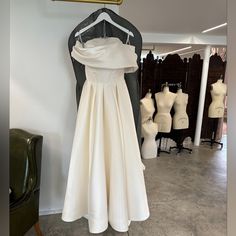 a dress on display in a shop with mannequins