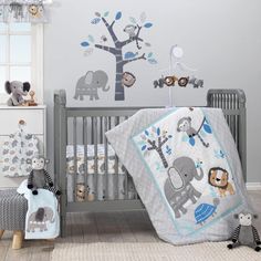 a baby crib with an elephant and giraffe theme