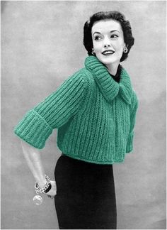 an old photo of a woman in a green sweater and black skirt with her hand on her hip