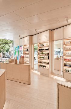 the inside of a store with shelves and counter tops filled with cosmetics products on display