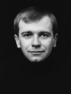 a black and white photo of a man looking at the camera with an intense look on his face