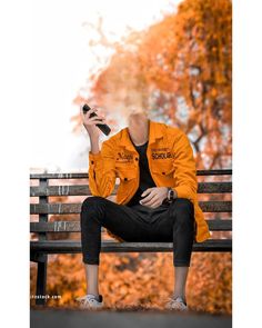 a mannequin dressed in an orange jacket and black pants sits on a park bench