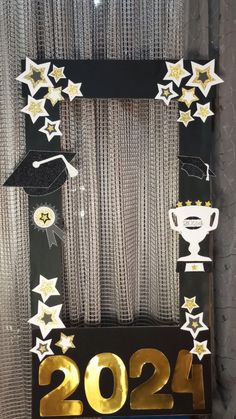 a graduation door decoration with gold stars on it