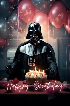 a darth vader birthday cake with candles on it and balloons in the background