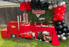 cars birthday party table with balloons and decorations