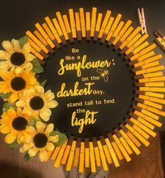 a sunflower wreath with the words, be like a sunflower on the darker day, stand tall to find light