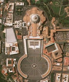 an aerial view of a large building in the middle of a city with lots of buildings