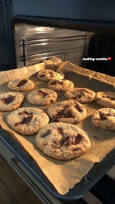 chocolate chip cookies are on a baking sheet in an oven, ready to go into the oven