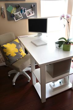 a white desk with a computer monitor and keyboard