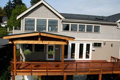 a house with a wooden deck and white doors