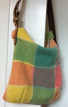 a multicolored purse hanging on a door handle