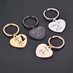 four different styles of heart shaped keychains with the names of two people on them