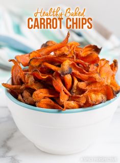 a bowl filled with carrot chips on top of a table