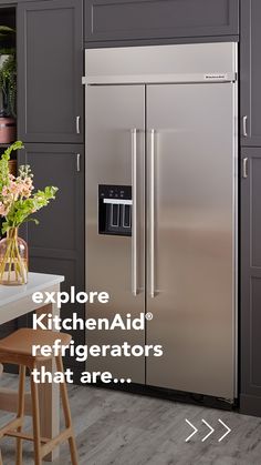 a stainless steel refrigerator in a kitchen with the words explore kitchen aid refrigerators that are