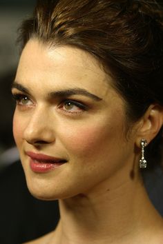 a close up of a person wearing earrings