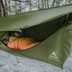 a tent in the snow with a sleeping bag inside