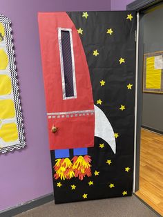 a door decorated with a rocket ship and stars