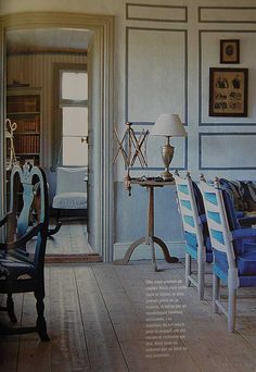 an image of a living room setting with blue and white chairs