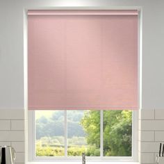 a pink roller shade in a kitchen window