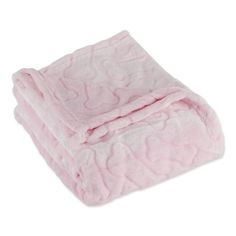 the pink blanket is folded up on top of it's white surface and has hearts