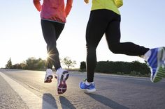 two women running down the road in bright colored clothes and sneakers, both wearing colorful shoes