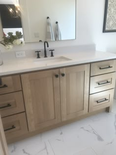 a bathroom vanity with two sinks and mirrors