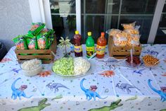 a table topped with lots of food next to a window