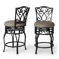 two black metal barstools with beige upholstered fabric seat covers and backrests