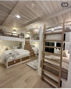 there are bunk beds in this room with stairs to the second floor and another bed on the other side