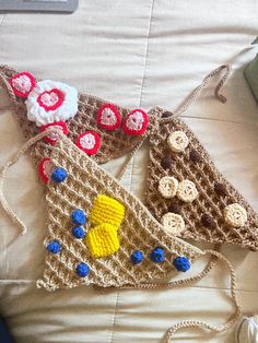 two crocheted purses sitting on top of a bed