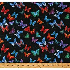 a black background with multicolored butterflies and a ruler on the bottom right side