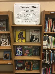 a book shelf filled with lots of books next to a sign that says, strange than fiction