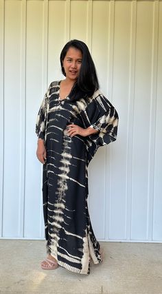 This kaftan, made from rayon fabric and hand dyed, is versatile for many occasions. It complements all body types with its long, hangs loose design and slits up both sides. It can be worn in many different stylish ways to make you look your best! DETAIL • All measurements are flat• Bust/ Waist/ Hips 34 in. (Circumference 68 in.)• Arms 11 in. (Circumference 22 in.)• Length 50 in. The model wear • V-Neck • Side slits• No pocket• Slipover style• All above measurement are flatFABRIC• 100% Rayon FIT• Flowy Maxi Dress With Natural Dye, Flowy Tie Dye Kaftan Tunic, Tie Dye Flowy Tunic Kaftan, Flowy Tie-dye Tunic Kaftan, Tie Dye Flowy Maxi Kaftan, Flowy Tie Dye Maxi Kaftan, Black Batik Print Kaftan For Summer, Black Batik Print Kaftan, Flowy V-neck Tie Dye Kaftan