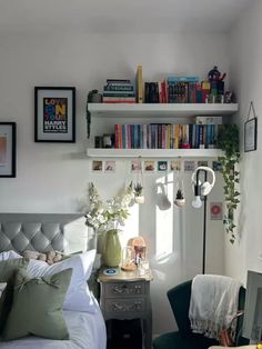 a bedroom with a bed, chair and bookshelf