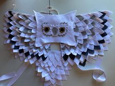 an owl mask made out of white paper