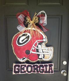 a door decorated with a football helmet and the word georgia on it