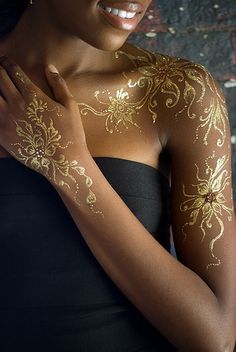 a woman with gold paint on her body