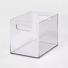 a clear plastic box with a handle on the top and bottom, sitting on a white surface