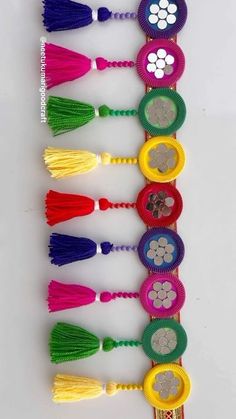 a row of colorful tassels with flowers on them