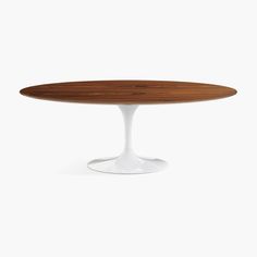 an oval wooden table with white base